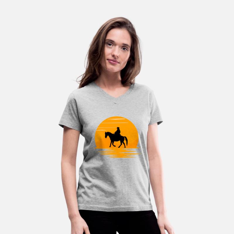 A cowboy walking on his horse in sunset